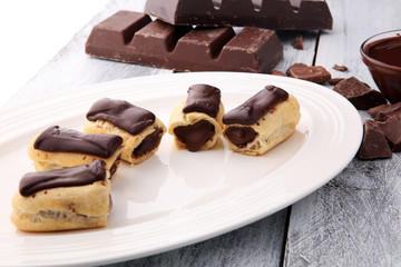 Traditional French dessert. Eclair with chocolate icing. Pastery concept