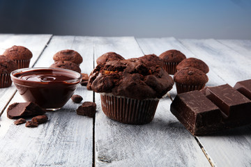 Chocolate muffins, homemade bakery on white wooden background