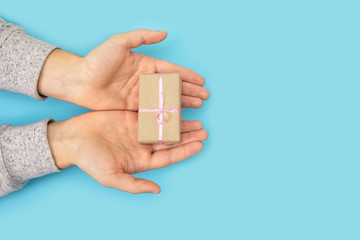 man's hand blue background gift palm open valentine lovers mother's day father love present