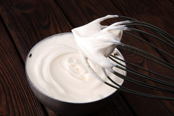 close up of a white whipped or sour cream in bowl