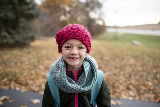 Portrait of girl standing on road during autumn