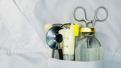 Nurse&acute;s uniform pocket drugs, stethoscope and test tube