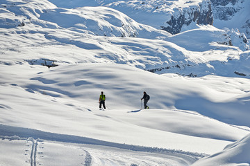 Naklejka na ściany i meble Skier climb on skis and sealskins.The ski slope and skiers at Passo Groste ski area ,italy