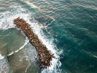 View from above on the breakwater in the sea