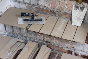 A workplace for a master from laying tiles. Tools and accessories as well as tiles when laying.