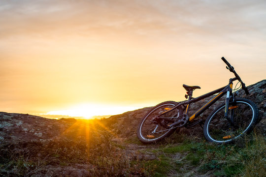 Mountain Bike on the Rocky Trail at Sunset. Extreme Sport Concept. Space for Text.