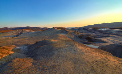 Fototapeta na wymiar Sunrise in the Muddy Volcanoes National Reservation in Romania,Berca,Buzau,Vulcanii Noroiosi. Muddy Volcanoes landscape.