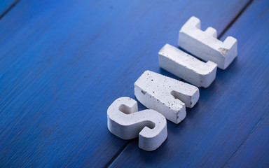 concrete letters on a wooden board