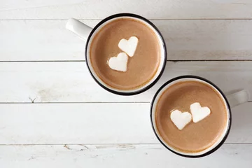 Wall murals Chocolate Two cups of hot chocolate with heart shaped marshmallows over a white wood background