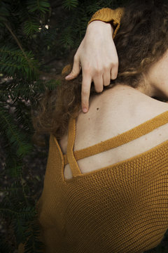 Woman wearing yellow sweater hand 