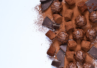Chocolate shonfet with praline, truffles, chocolate, cocoa. Chocolate photo background.