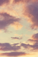 The vertical view of sky background or texture at the sunset time with clouds. Copy space