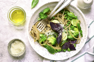 Whole wheat spaghetti with green vegetables ( zucchini,green pea and broccoli) .Top view with copy space.