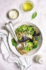 Whole wheat spaghetti with green vegetables ( zucchini,green pea and broccoli) .Top view with copy space.