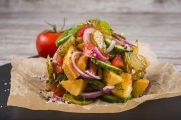 Delicious country salad with potatoes and cucumbers
