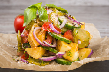 Delicious country salad with potatoes and cucumbers