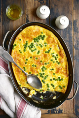 Frittata with potato, cheese and green pea.Top view.