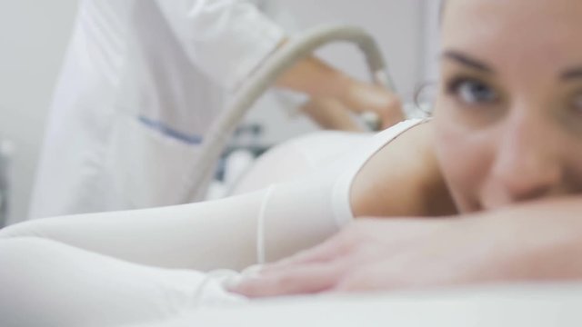 Woman enjoys massage with lpg apparatus