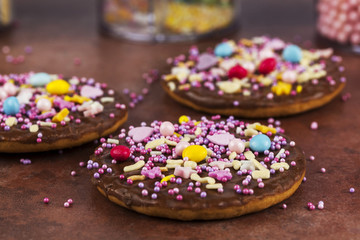 Chocolate biscuits sprinkled with colourful candy shapes