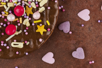 Segment of a chocolate biscuits sprinkled with colourful candy t