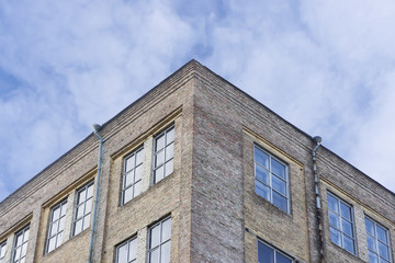 Corner of a building against a blue sky in the spring.