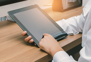 Close up hands touching screen of business woman using tablet on her desk