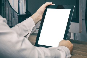 Business woman holding tablet on her desk , white screen