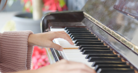 Woman hand playing the piano