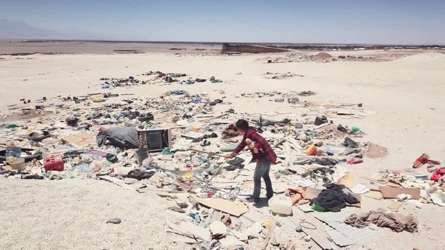 Aerial view of vagabond searching trash to recycle in a public dump in Atacama Desert. 4k