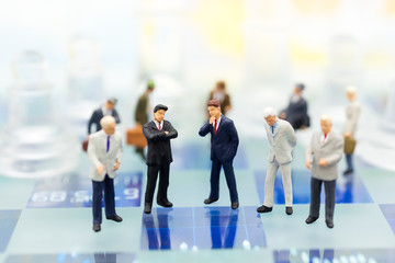 Miniature people, Group Businessmen standing on the chess game, thinking solution for the business game,  use as a business competition concept.