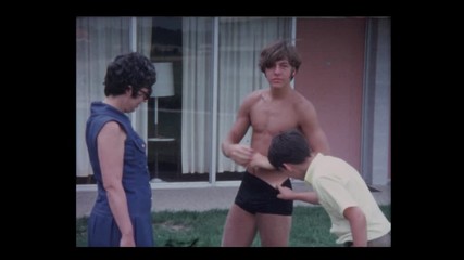 1970 Mother and 2 sons outside motel pool