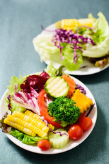 Mixed vegetables salad on white dish, healthy food