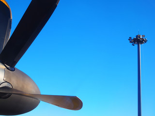 Side view part of airplane old black small steel metal, yellow border blade propeller under bright...