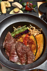 Japanese food - Sliced beef steak with fried vegetables cover rice 