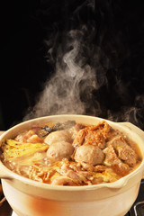 Cooking spicy hot pot boiling on the fire burning stove  