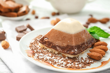Yummy dessert with caramel and almond on plate, closeup
