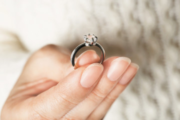 Woman holding luxury engagement ring, closeup