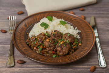 Traditional Italian meatballs Polpette in a ceramic dish with a side dish of rice. 