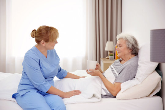 Senior woman with caregiver at home