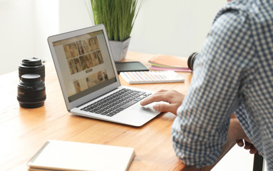 Fototapeta premium Photographers with laptop in office