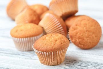 Delicious cupcakes on wooden table, closeup