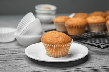 Plate with delicious cupcake on table, closeup