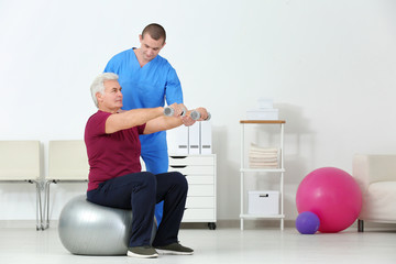 Physiotherapist working with patient in rehabilitation centre