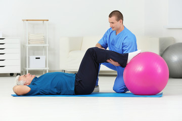 Physiotherapist working with patient in rehabilitation centre