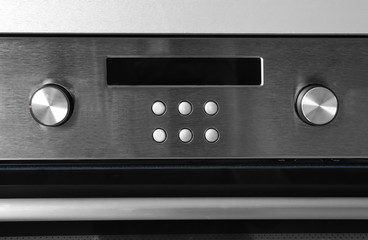 New electric oven with control buttons, closeup
