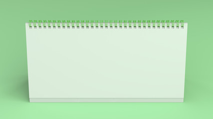 White table calendar mock-up on green surface