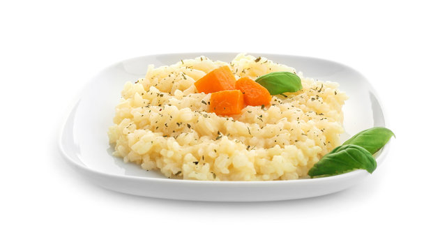 Plate with delicious pumpkin risotto on white background