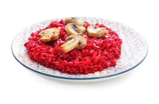 Plate with tasty beetroot risotto with mushrooms on white background