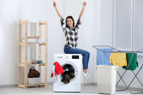 Young Woman Doing Laundry At Home