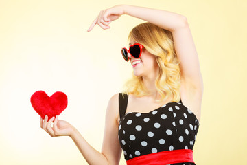 Woman holding red heart love symbol